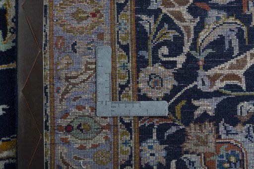 Backside of handmade 2000s Kashan rug showing knot structure and weave density