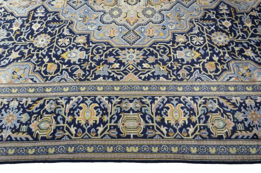 Corner detail of 2000s Kashan rug showing border pattern and Wool pile