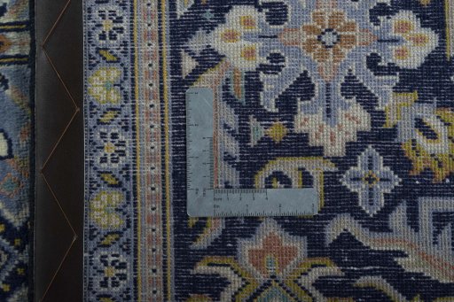 Backside of handmade 2000s Kashan rug showing knot structure and weave density