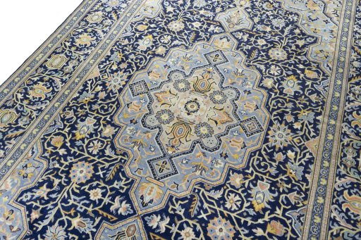 Backside of handmade 2000s Kashan rug showing knot structure and weave density