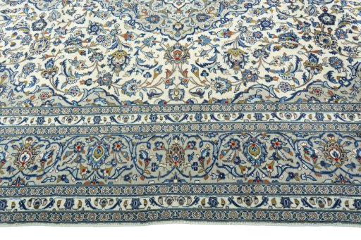 Corner detail of 2000s Kashan rug showing border pattern and Wool pile