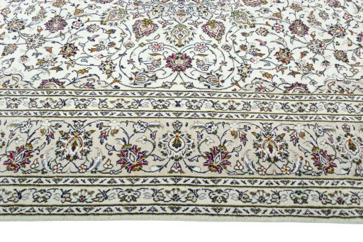 Corner detail of 2000s Kashan rug showing border pattern and Wool pile