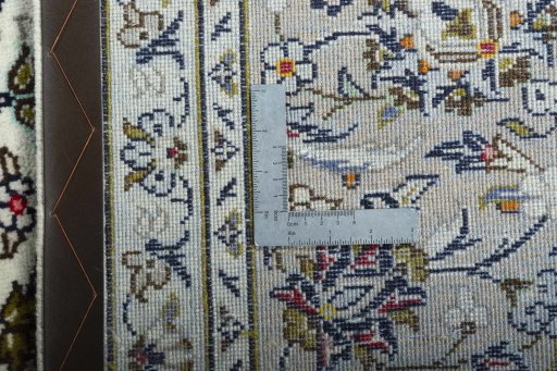 Backside of handmade 2000s Kashan rug showing knot structure and weave density