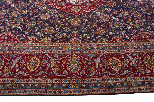 Corner detail of 2000s Kashan rug showing border pattern and Wool pile
