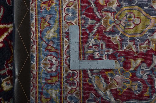 Backside of handmade 2000s Kashan rug showing knot structure and weave density