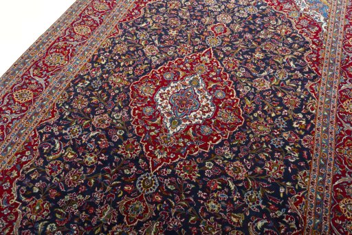 Backside of handmade 2000s Kashan rug showing knot structure and weave density