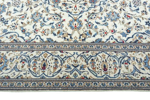 Corner detail of 2000s Kashan rug showing border pattern and Wool pile