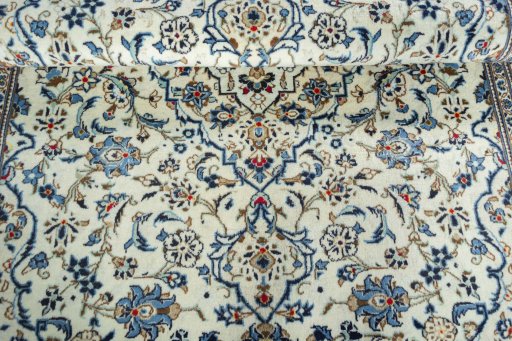 Close-up detail of 2000s Kashan rug from Iran / Persia showing Wool weave