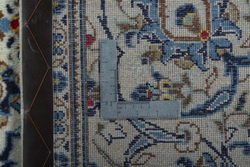 Backside of handmade 2000s Kashan rug showing knot structure and weave density