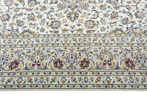 Corner detail of 2000s Kashan rug showing border pattern and Wool pile