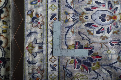 Backside of handmade 2000s Kashan rug showing knot structure and weave density