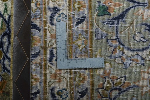 Backside of handmade 2000s Kashan rug showing knot structure and weave density