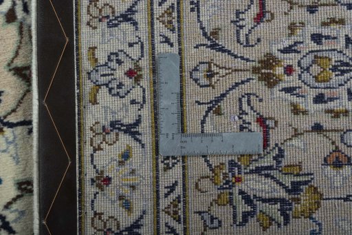Backside of handmade 2000s Kashan rug showing knot structure and weave density