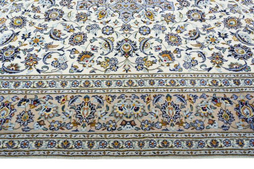 Corner detail of 2000s Kashan rug showing border pattern and Wool pile