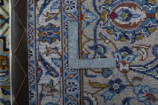 Backside of handmade 2000s Kashan rug showing knot structure and weave density