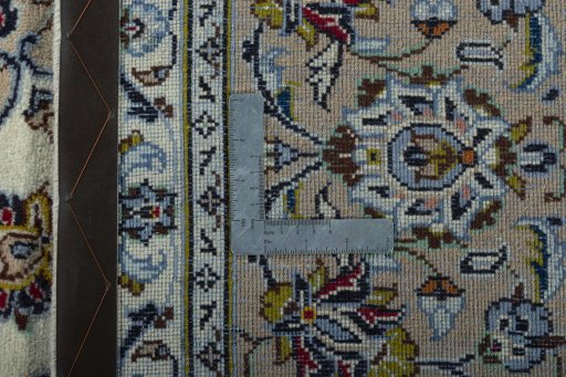 Backside of handmade 2000s Kashan rug showing knot structure and weave density