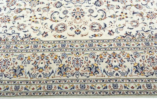 Corner detail of 2000s Kashan rug showing border pattern and Wool pile