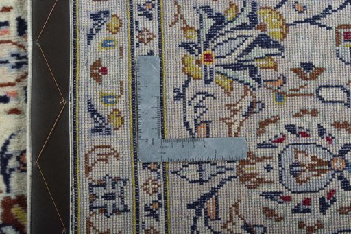 Backside of handmade 2000s Kashan rug showing knot structure and weave density