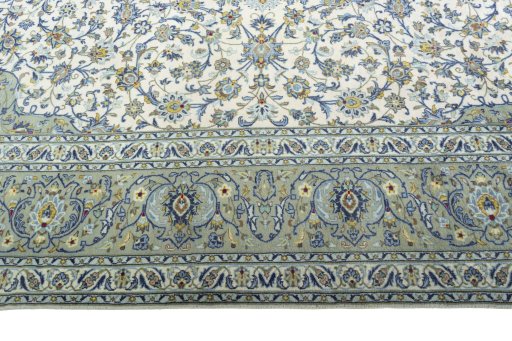 Corner detail of 2000s Kashan rug showing border pattern and Cork pile