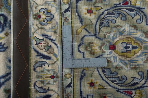 Backside of handmade 2000s Kashan rug showing knot structure and weave density