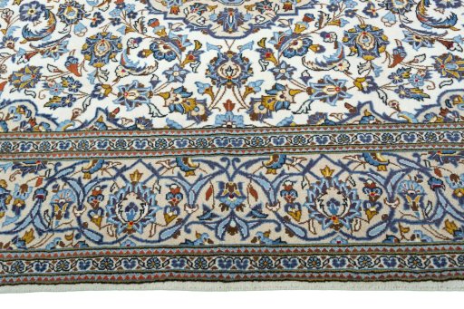 Corner detail of 2000s Kashan rug showing border pattern and Wool pile