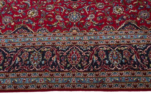 Corner detail of 2000s Kashan rug showing border pattern and Wool pile