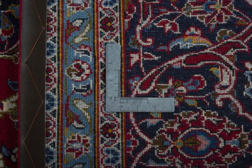 Backside of handmade 2000s Kashan rug showing knot structure and weave density