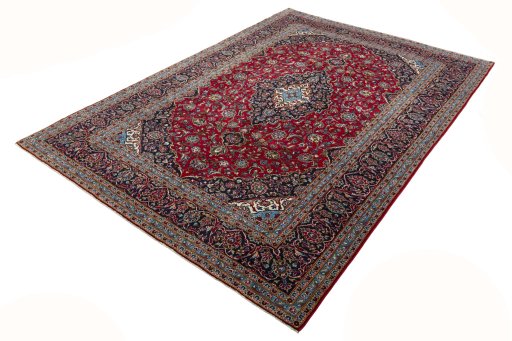 Corner detail of 2000s Kashan rug showing border pattern and Wool pile