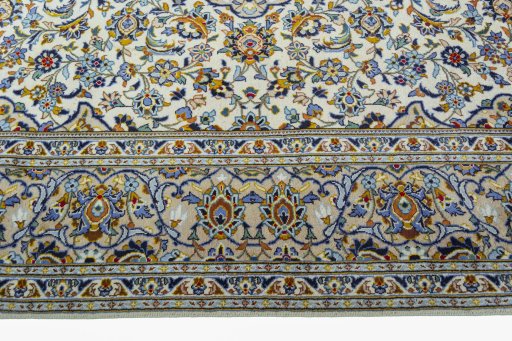 Corner detail of 2000s Kashan rug showing border pattern and Wool pile
