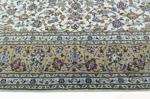 Corner detail of 2000s Kashan rug showing border pattern and Wool pile
