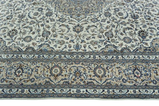Corner detail of 2000s Kashan rug showing border pattern and Wool pile