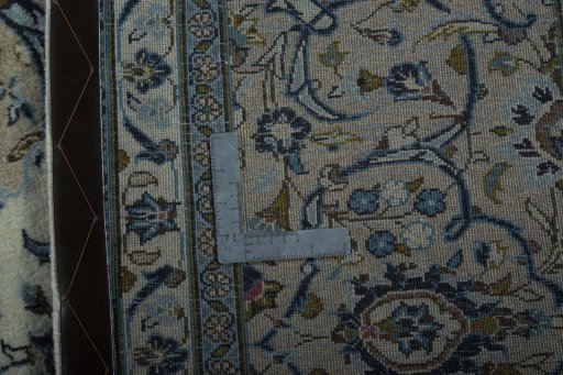 Backside of handmade 2000s Kashan rug showing knot structure and weave density