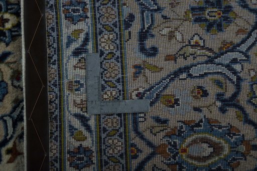 Backside of handmade 2000s Kashan rug showing knot structure and weave density