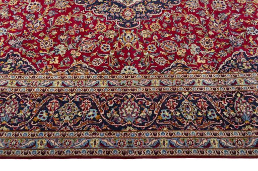 Corner detail of 2000s Kashan rug showing border pattern and Wool pile