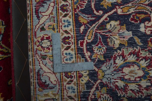 Backside of handmade 2000s Kashan rug showing knot structure and weave density