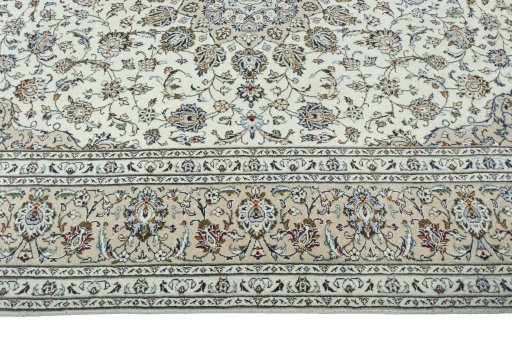 Corner detail of 2000s Kashan rug showing border pattern and Wool pile