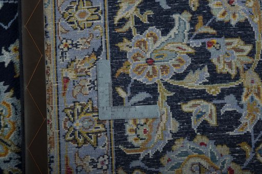 Backside of handmade 1970s Kashan rug showing knot structure and weave density