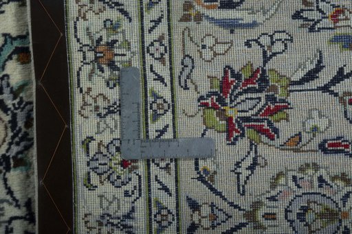 Backside of handmade 2000s Kashan rug showing knot structure and weave density