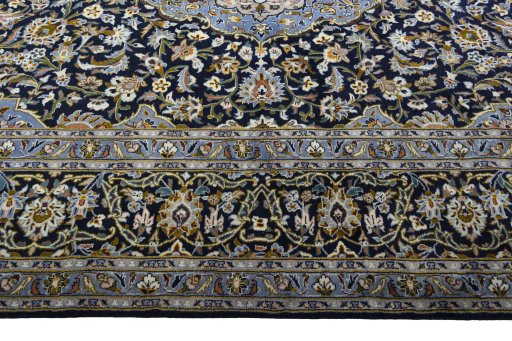 Corner detail of 2000s Kashan rug showing border pattern and Wool pile