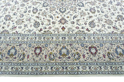 Corner detail of 2000s Kashan rug showing border pattern and Wool pile