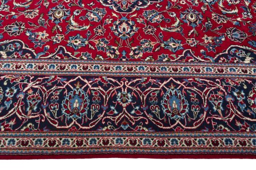 Corner detail of 2000s Kashan rug showing border pattern and Wool pile
