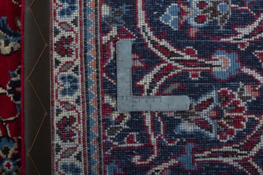 Backside of handmade 2000s Kashan rug showing knot structure and weave density