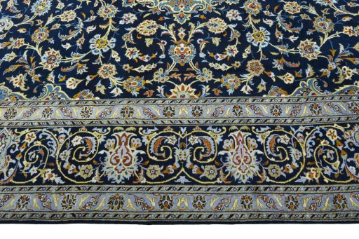 Corner detail of 2000s Kashan rug showing border pattern and Wool pile