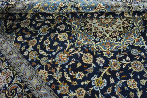 Close-up detail of 2000s Kashan rug from Iran / Persia showing Wool weave