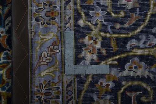 Backside of handmade 2000s Kashan rug showing knot structure and weave density