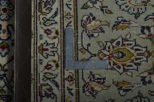 Backside of handmade 2000s Kashan rug showing knot structure and weave density