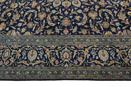 Corner detail of 2000s Kashan rug showing border pattern and Wool pile