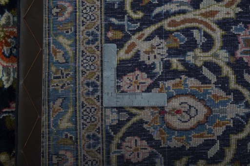 Backside of handmade 2000s Kashan rug showing knot structure and weave density