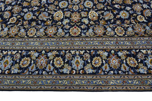 Corner detail of 2000s Kashan rug showing border pattern and Wool pile