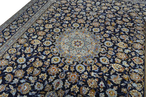 Backside of handmade 2000s Kashan rug showing knot structure and weave density